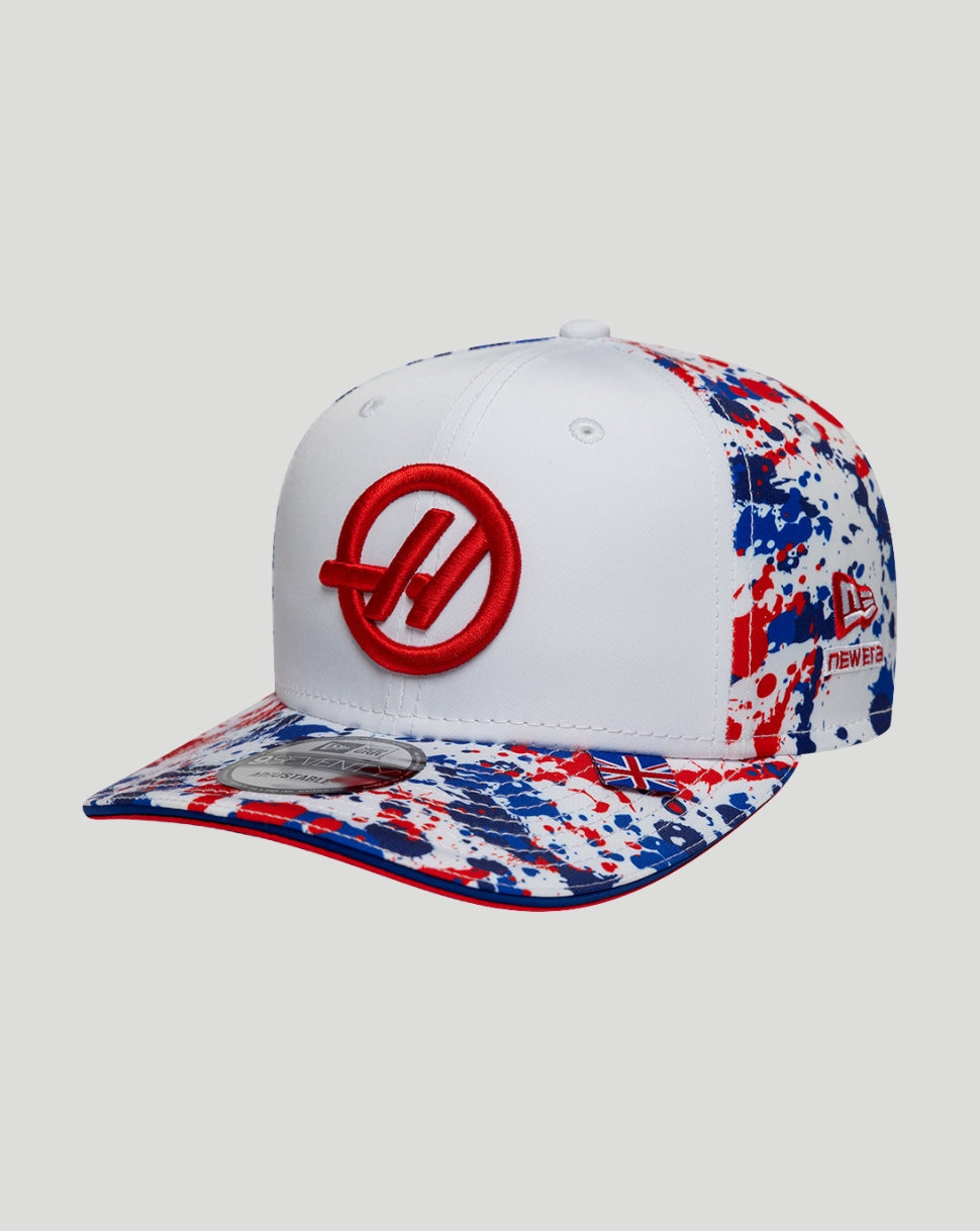 White cap with red logo and multicolored pattern on a light gray background