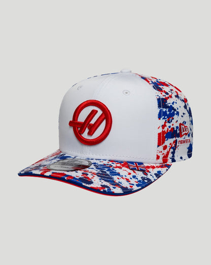 White cap with red logo and multicolored pattern on a light gray background