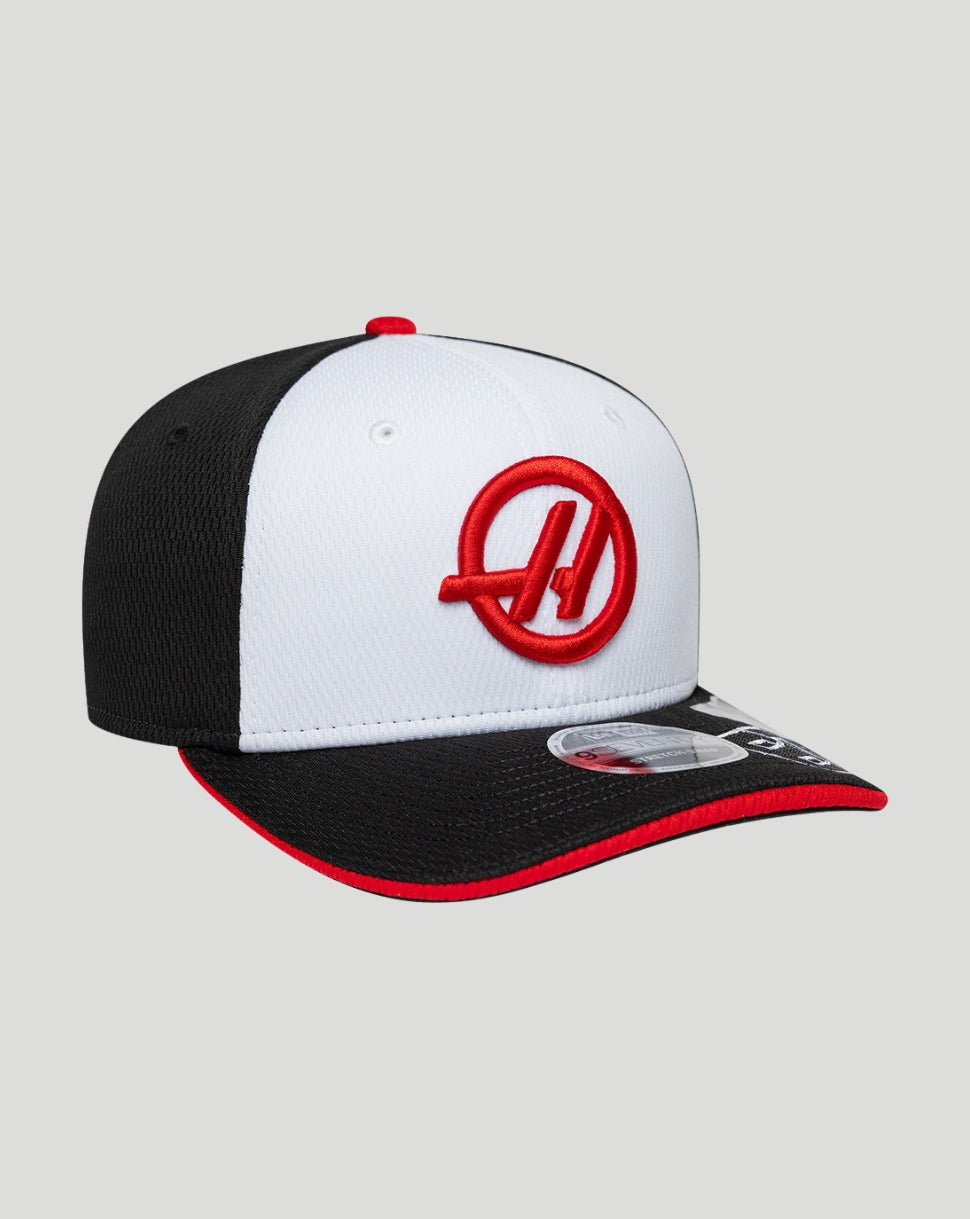 Black and white cap with a red logo on a gray background