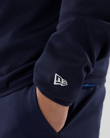 Navy blue sweatshirt with a visible brand logo on the sleeve against a neutral background