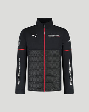 A black Puma x Porsche Motorsport zip-up jacket with a quilted lower panel, featuring white logos, a red center zipper, and red sleeve stripes, shown on a solid gray background.