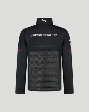 Black Porsche x Puma athletic jacket with a high collar, white Porsche logo on the chest, and a subtle checkerboard pattern on the lower front panel, shown against a light gray background.