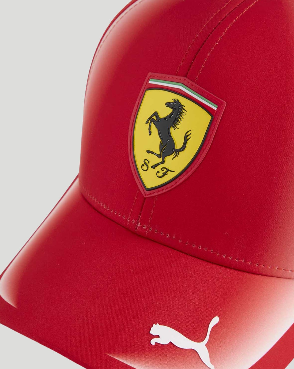 Close-up of the red cap front with Ferrari shield crest and Italian flag striping above and a white Puma logo on the brim