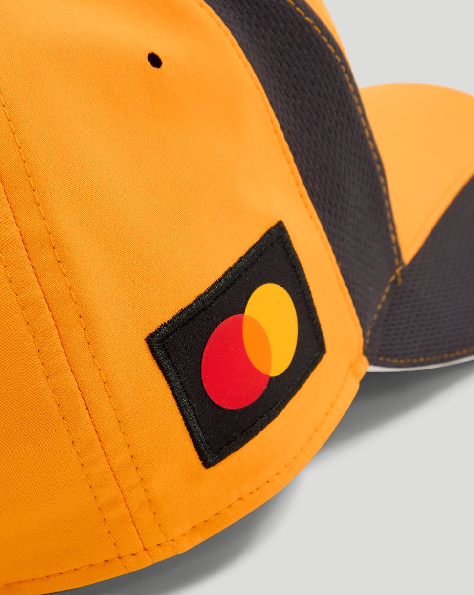Close up of the papaya orange cap showing the Mastercard logo patch on the side