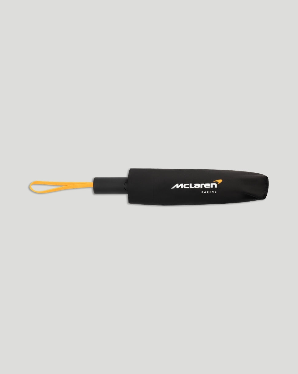 Closed black McLaren umbrella with a yellow wrist strap and McLaren Racing logo