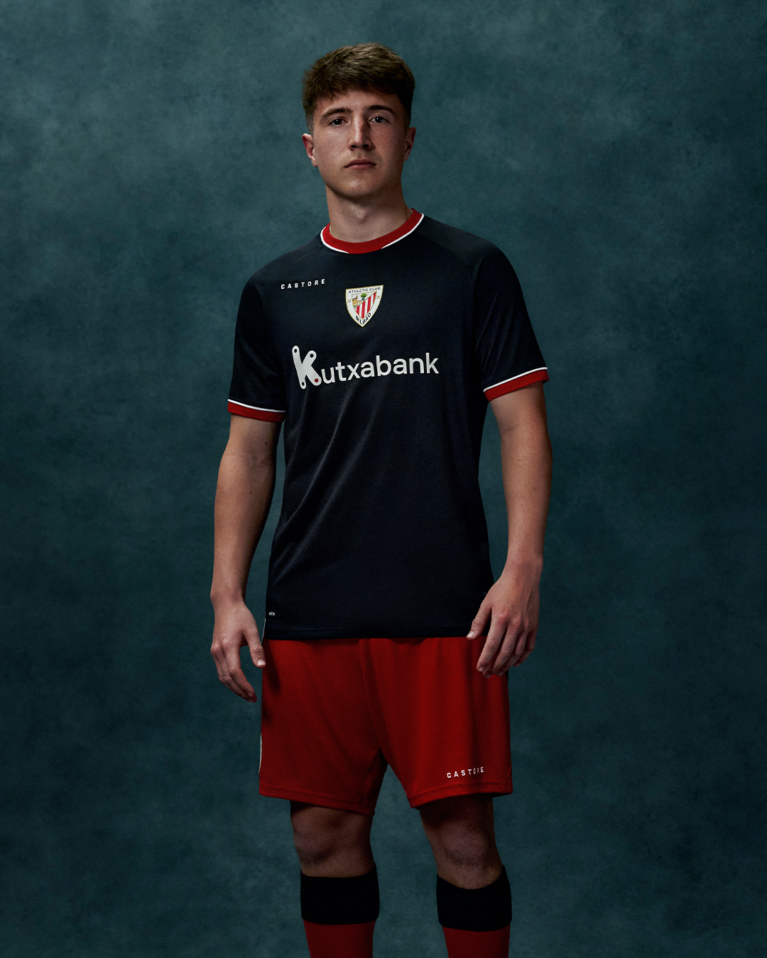Athletic Club Men's 26/27 Away Pro Shirt on a model black jersey with red trim and crest