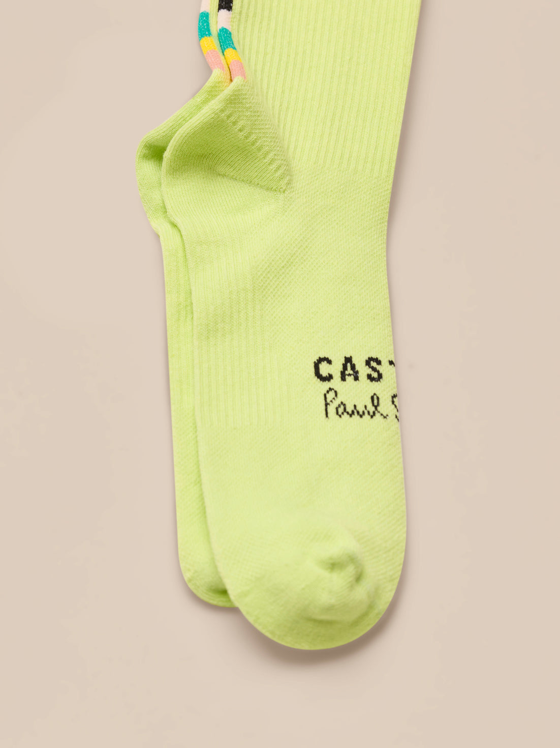 Pair of neon green socks with text on a beige background