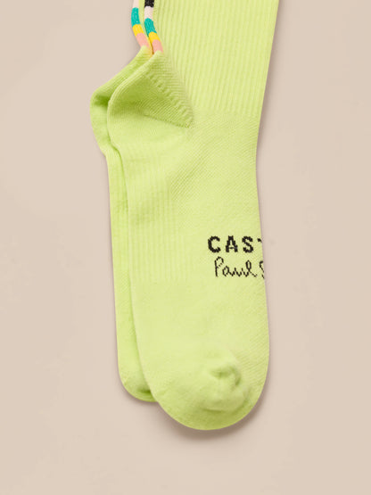 Pair of neon green socks with text on a beige background