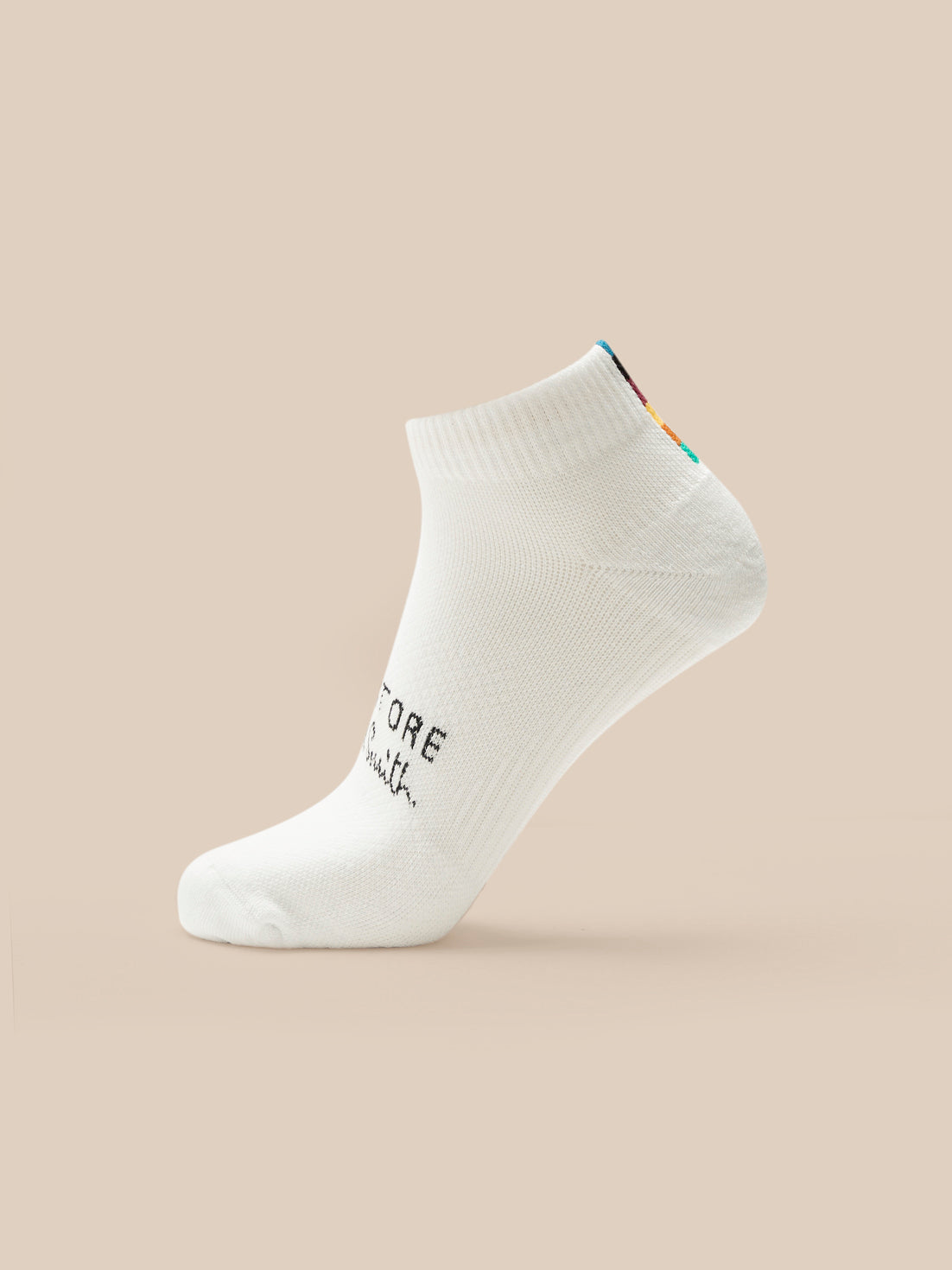 White ankle sock with text on a beige background
