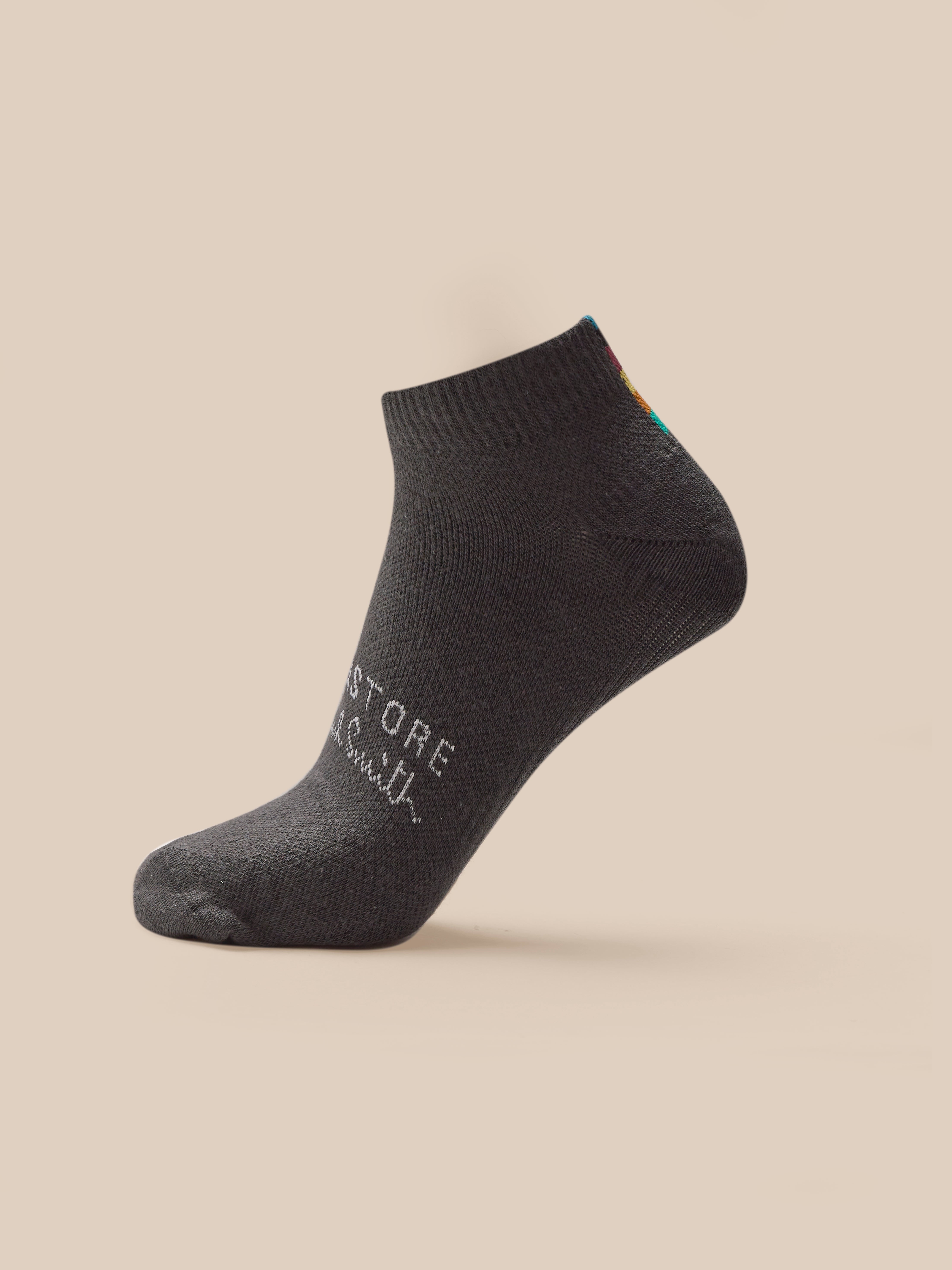 Dark gray ankle sock with text on a beige background
