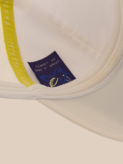 Close-up of a label on a white garment with yellow trim.