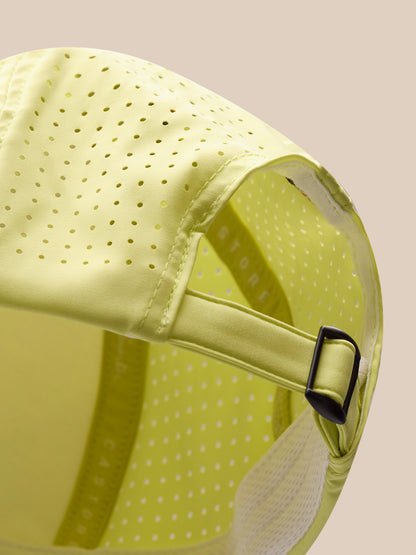 Yellow cap with a textured surface and black buckle on a beige background