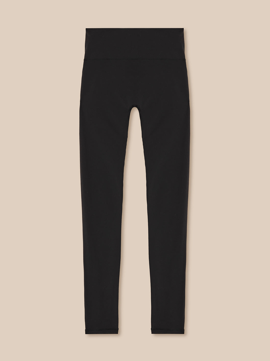 Black leggings on a beige background