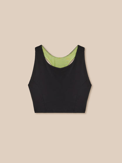 Black tank top with green lining on a beige background