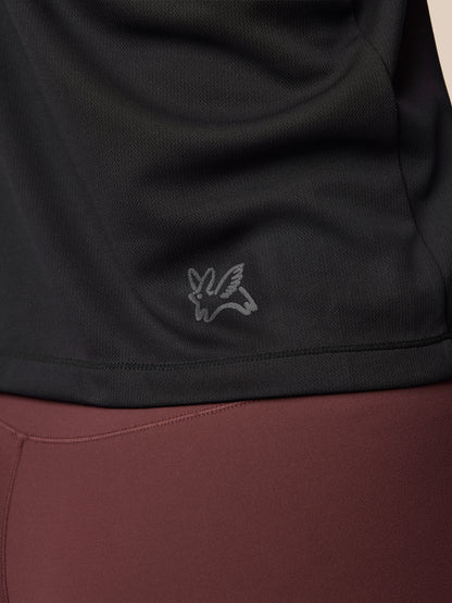 Close-up of a black and brown garment with a logo on the black section.