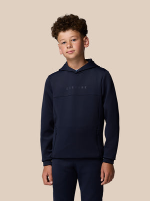 Boy wearing navy Junior Flex Scuba hoodie with hood up and Castore branding on chest.