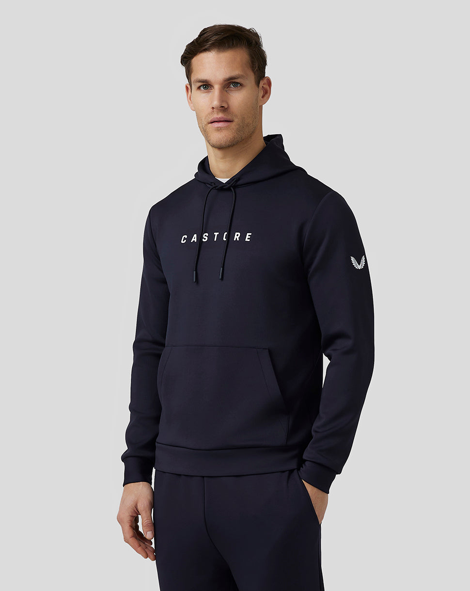 Male model wearing navy Castore Flex Hoodie front view with drawstring hood and large front kangaroo pocket