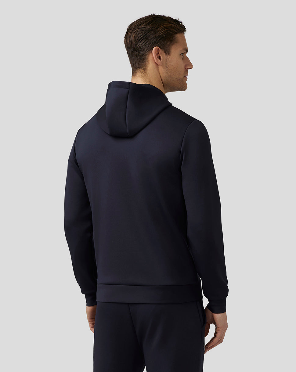 Back view of male model wearing navy Castore Flex Hoodie with hood resting on the upper back