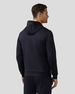 Back view of male model wearing navy Castore Flex Hoodie with hood resting on the upper back