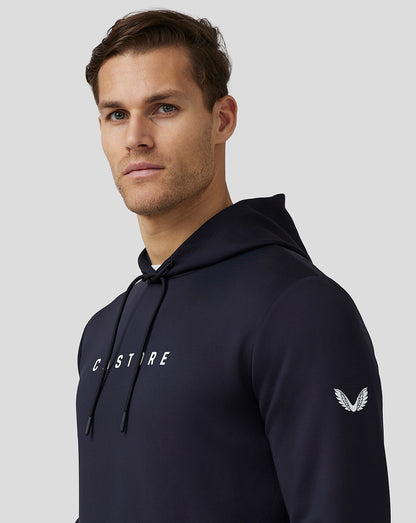 Close-up of navy Castore Flex Hoodie chest with CASTORE logo and sleeve emblem