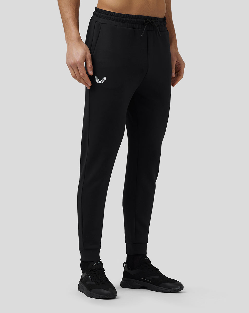Model in black Flex Joggers with drawstring waistband and CASTORE logo on the thigh.