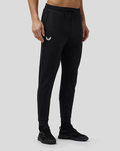 Model in black Flex Joggers with drawstring waistband and CASTORE logo on the thigh.