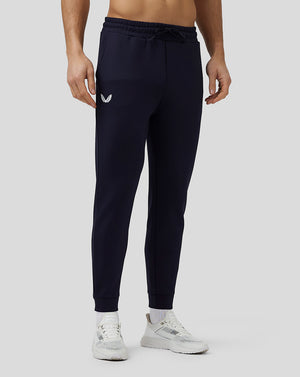 Male model in navy Flex Joggers with side branding and elastic cuffs