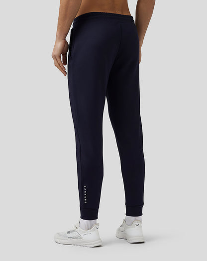 Back view of navy Flex Joggers with Castore logo along the leg and ribbed cuffs