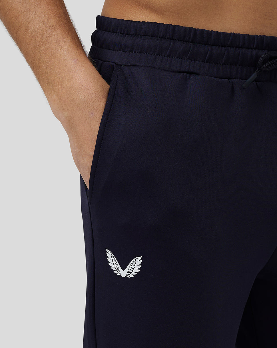 Navy Flex Joggers close-up showing CASTORE wing logo on the leg and cuffed ankle.