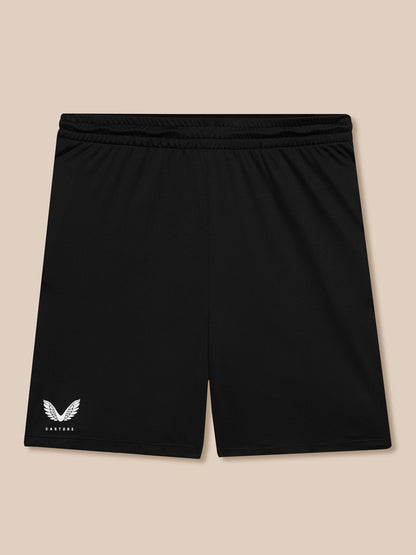 Back view of black shorts with elastic waistband and Castore wing logo at left hem.