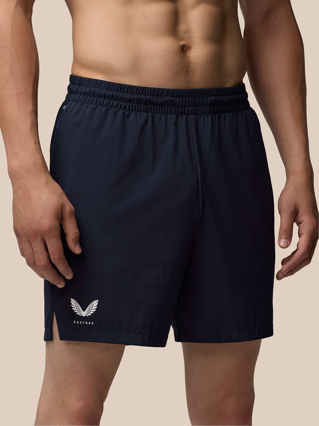 Navy Adapt 7 inch shorts with elastic waistband and side pocket; Castore branding on the thigh.