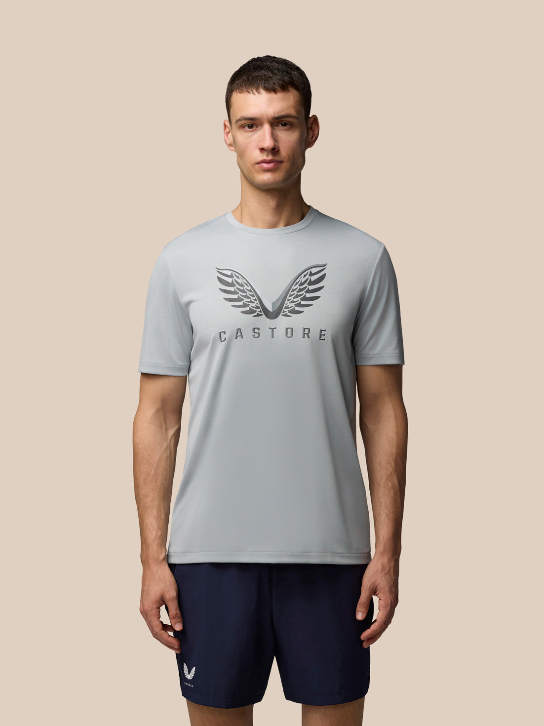 Male model wearing grey Adapt Graphic Training T-Shirt with Castore wings logo on the chest.