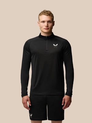 Front view of a man wearing Adapt Training quarter-zip top in black with stand collar and Castore logo on the left chest
