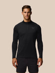 Male model wearing black Adapt Training 1/4 Zip Top with front quarter zip and left chest logo.