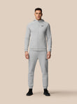 Male model wearing grey Adapt Fleece joggers with zip pockets and drawstring waist