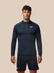 Male model in navy Apex Training 1/4 Zip Top with stand collar and Castore logo on chest