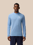 Male model wearing sky blue Apex Training quarter-zip top with textured knit fabric and left chest logo.
