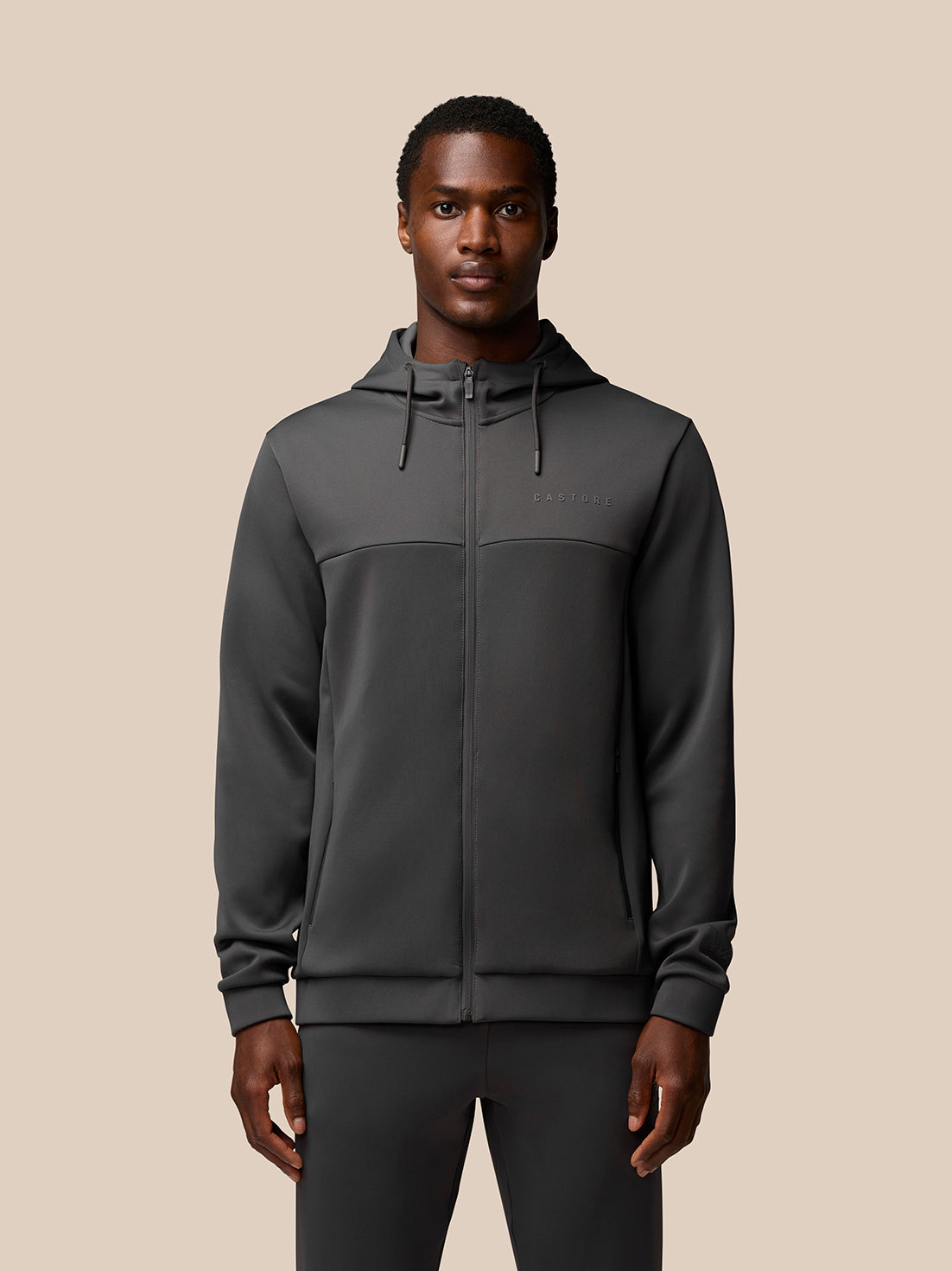 Male model wearing charcoal Flex Lifestyle Full Zip jacket with hood, front zip and water resistant pockets.