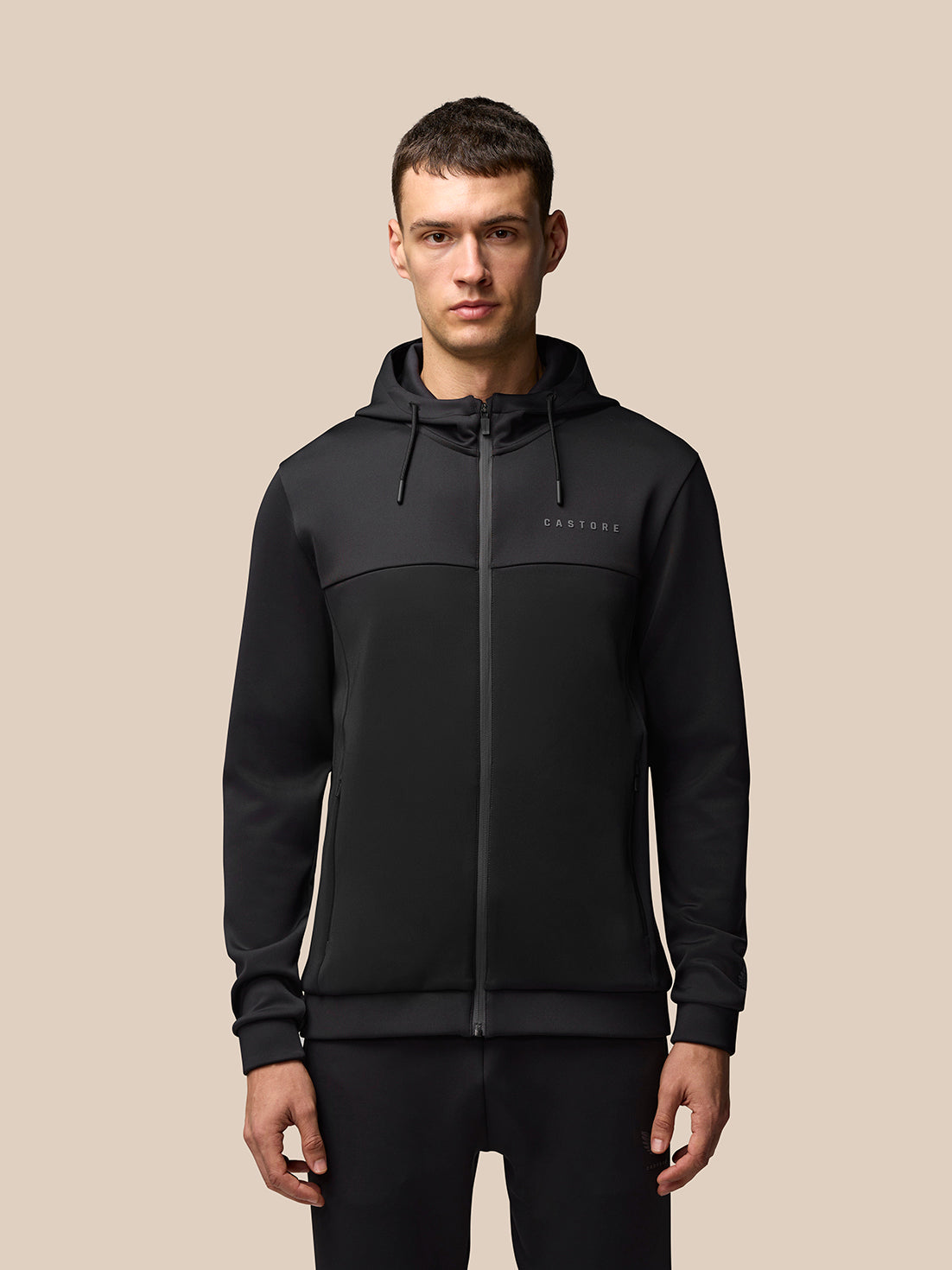 Male model wearing black two tone Flex Lifestyle Full Zip jacket with hood and front pockets
