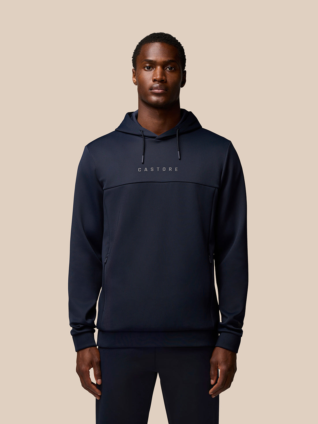 Front view of a man wearing navy Flex Lifestyle Hoodie with Castore branding on the chest