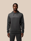 Front view of a male model wearing the Charcoal Flex Lifestyle Hoodie with the CASTORE logo on the chest and a drawstring hood