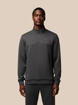 Male model wearing charcoal Flex Lifestyle 1/4 Zip top front view with chest branding
