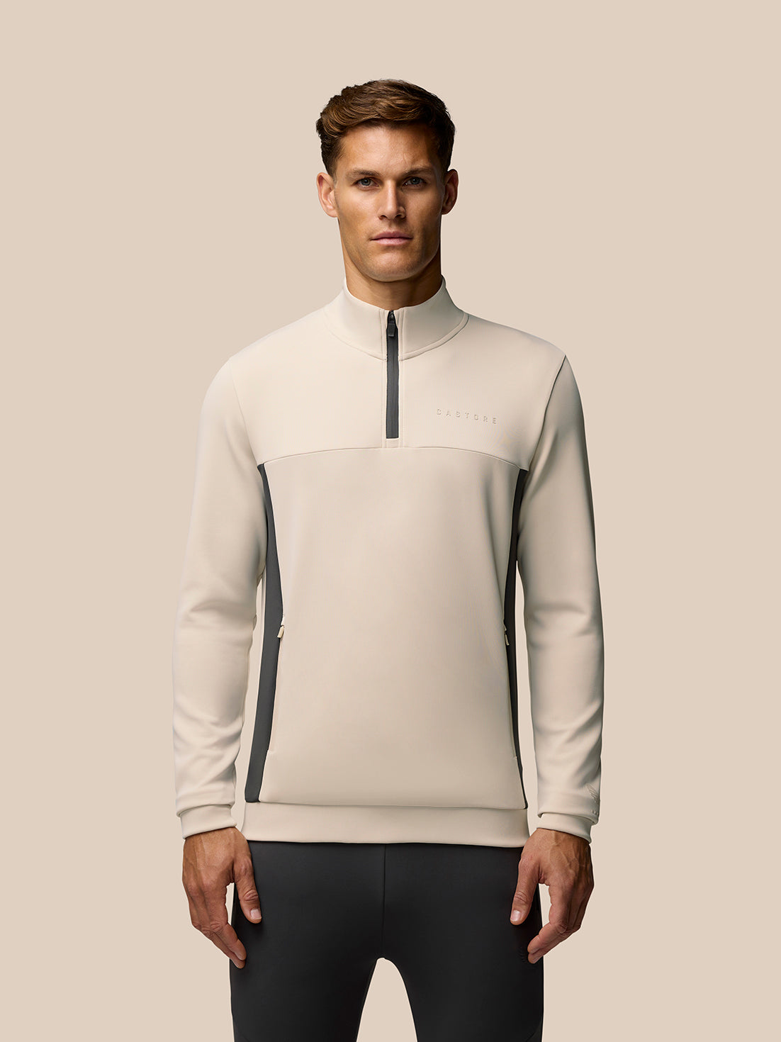 Beige Flex Lifestyle 1/4 Zip top on a model with high collar and zip placket
