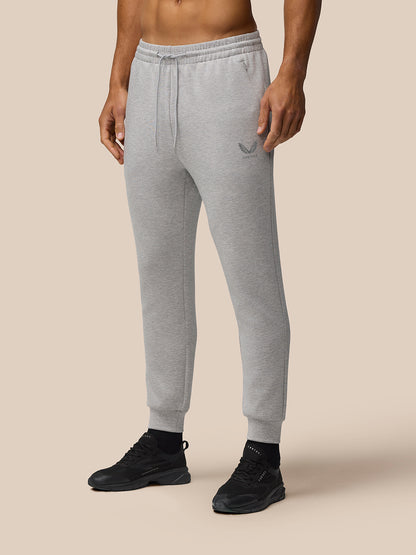 Male model in grey marl Travel Lifestyle Joggers with drawstring waist and cuffed hems, logo on left thigh.
