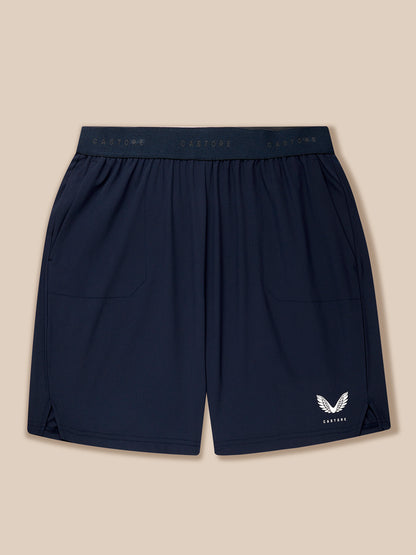 Navy blue shorts with a logo on a beige background