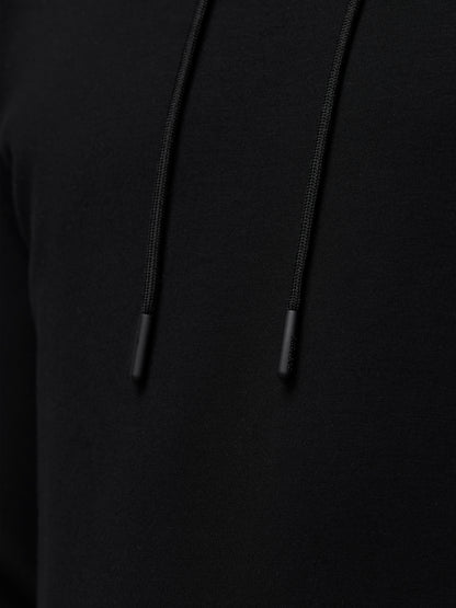 Close up of black Travel Lifestyle Hoodie fabric with drawstrings and tips.