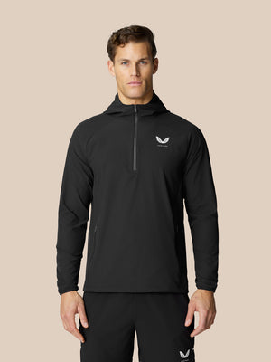 Man in black Flow Training Hoodie with half zip and white Castore logo on chest