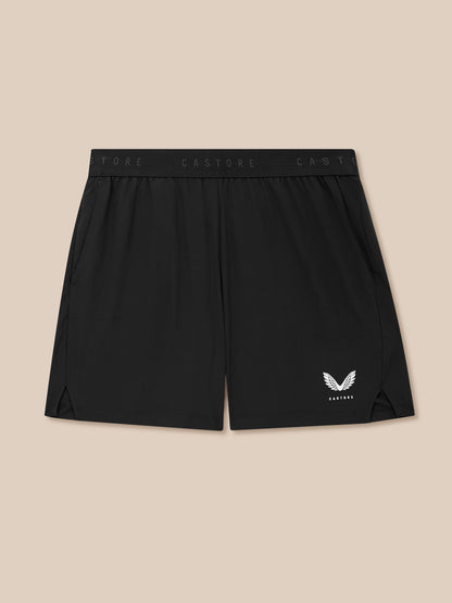 Black shorts with a logo on a beige background