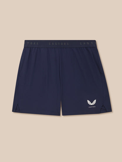 Navy shorts with a brand logo on a beige background