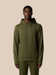 Male model wearing green Flex Lifestyle Thermo Hoodie with hood and front zipper chest logo